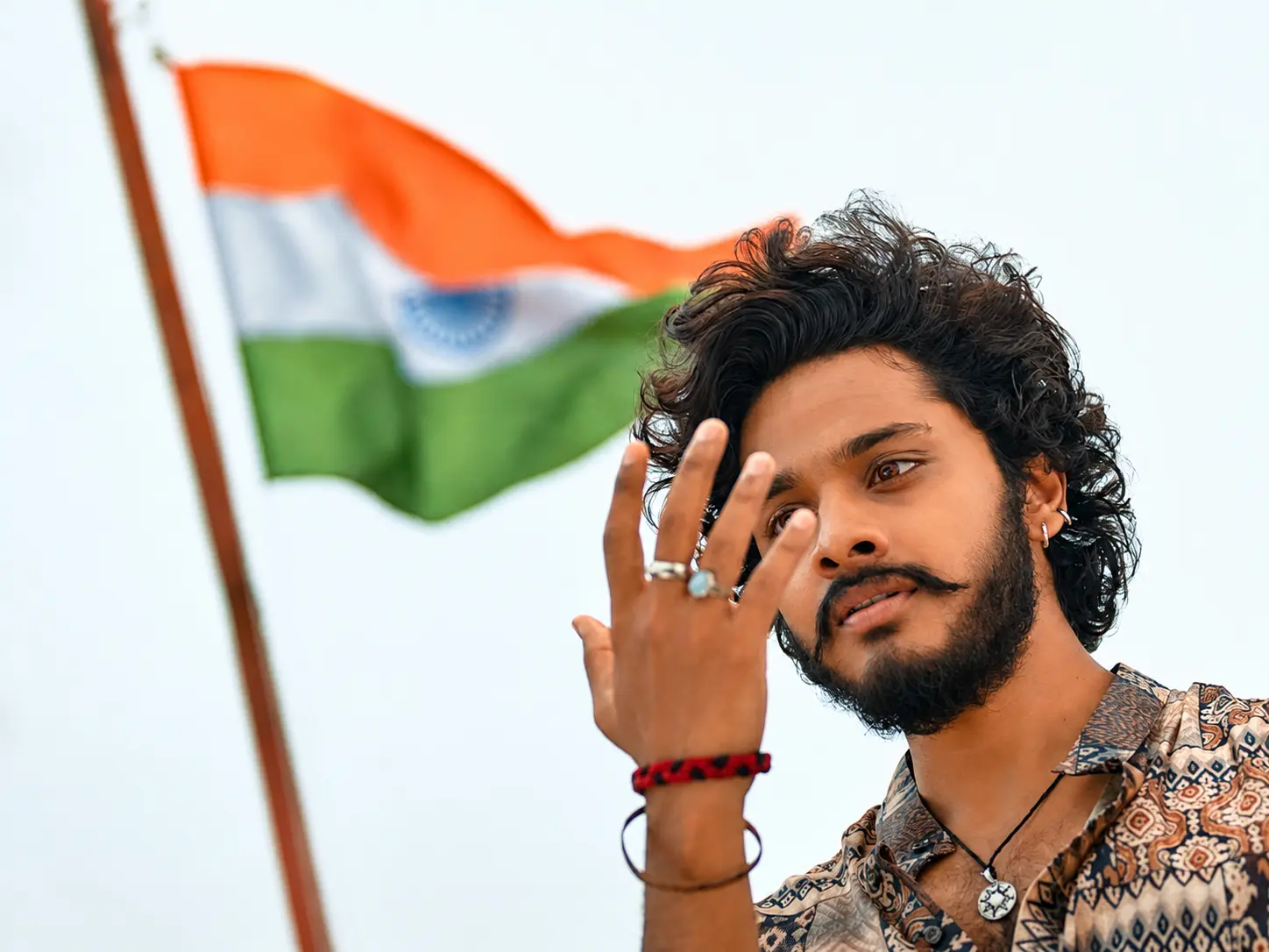 HanuMan character standing before the Indian flag
